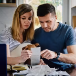 3_Man-And-Woman-Checking-Payment-Bills-In-The-Kitchen-At-Home-Planning-Family-Budget.jpg