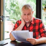 4_Worried-man-checking-bills-at-home.jpg