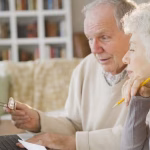 8_Senior-couple-going-over-bills-with-laptop.jpg