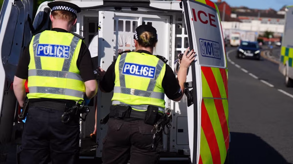 1_EMBARGOED-TO-0001-THURSDAY-SEPTEMBER-24-Police-officers-arrest-a-person-after-raiding-a-property-i.avif
